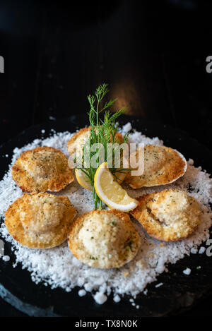 deep fried Hokkaido Scallops Shell with crusty bread serve with lemon and salt. Stock Photo