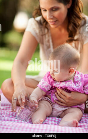 Woman having a picnic with her baby daughter. Stock Photo