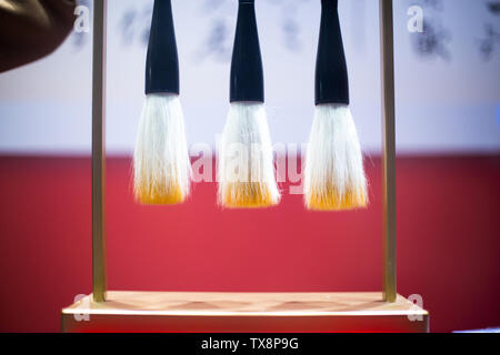 hanging calligraphy brushes on steel frame Stock Photo