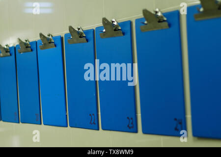 blue color information clip board on wall Stock Photo