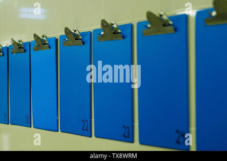 blue color information clip board on wall Stock Photo