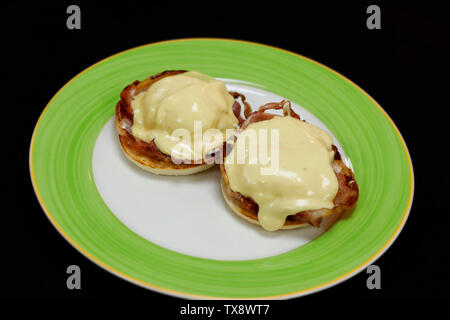 egg Benedict with poach egg, bacon and spinach Stock Photo