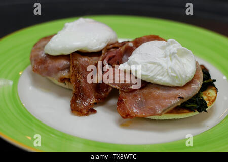 egg Benedict with poach egg, bacon and spinach Stock Photo
