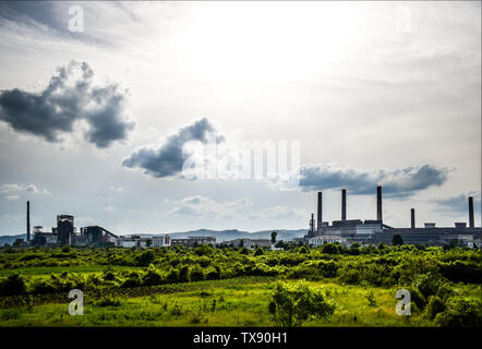 View of old power plant with big concrete furnaces . Fallen chemical communist industry. Stock Photo