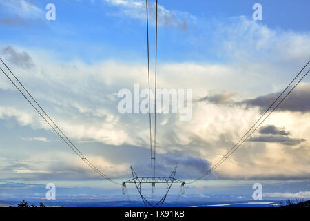 Electric tower in blue sky with clouds at sunset Stock Photo