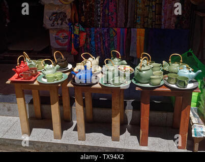 Tea ports, cups and saucers tea sets in multiple colours, Ubud craft market, Bali, Indonesia Stock Photo