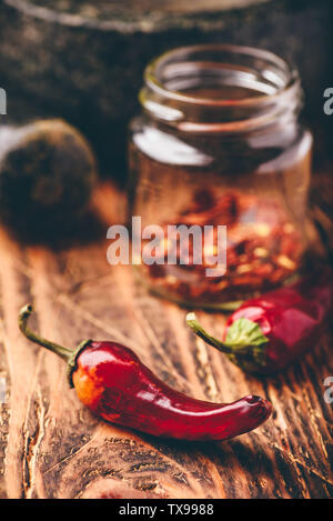 Sun dried red chili peppers on wooden surface Stock Photo