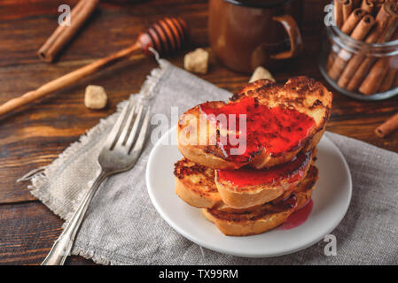 Stack of french toasts with berry marmalade on white plate Stock Photo