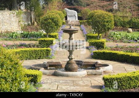 Buxus. Box hedging seen from the fountain in the Rose Garden at Belvoir Castle, England, UK Stock Photo
