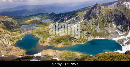 Panoramic, colorful, sunlit view from the Lakes summit on Rila mountain of The Twin lake, The Trefoil lake, Fish Lake and The Lower lake Stock Photo