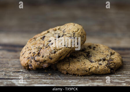 Two Freshly Baked Chocolate Cookies on Rustic Wooden Table. Sweet Biscuits. Homemade pastry. Stock Photo
