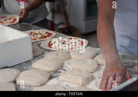 Preparing pizza Margherita dough on a countertop. Stock Photo