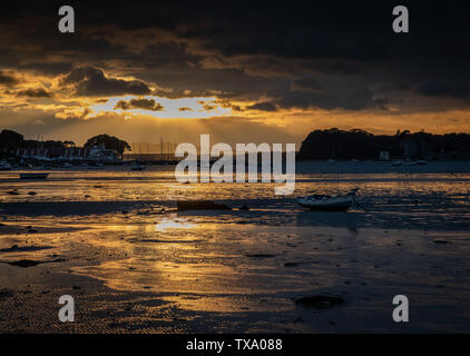 Sun setting over Poole Harbour with tide out Stock Photo