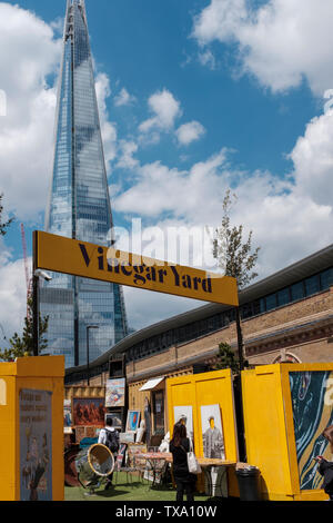 UK,London-Vinegar Yard is an urban garden open seven days a week, with food stalls, vintage clothing and antiques traders, and a bar pulling local bee Stock Photo