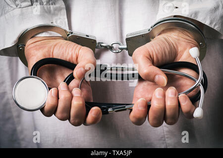 Handcuffed doctor. Medical crime concept, closeup Stock Photo