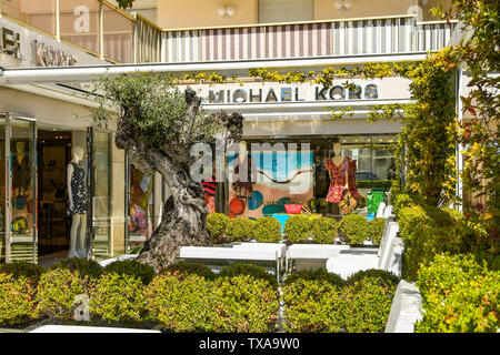 CANNES, FRANCE - APRIL 2019: Signs outside the Michael Kors store on the seafront in Cannes. It is a well known brand of designer goods. Stock Photo