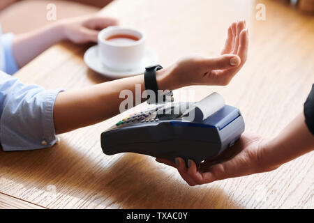 Making contactless payment with smartwatch Stock Photo