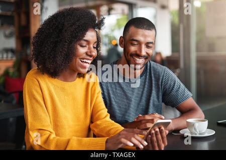 Young couple watching video on mobile phone Stock Photo