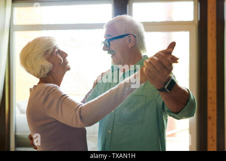 Happy and affectionate senior couple holding by hands Stock Photo