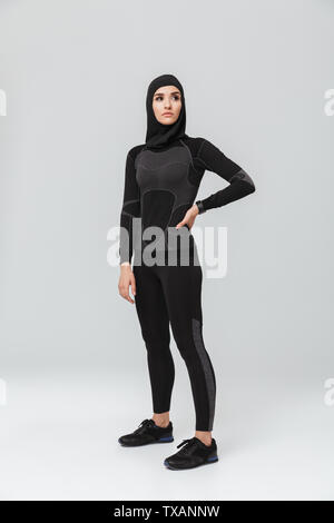 Image of young woman fitness muslim posing isolated over white wall background. Stock Photo