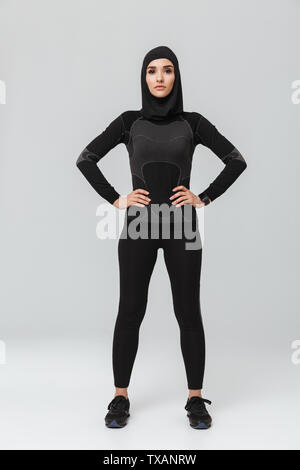 Image of young woman fitness muslim posing isolated over white wall background. Stock Photo