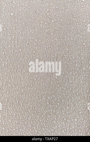 Texture of water drops on fabric textile close-up. Rain background Stock Photo