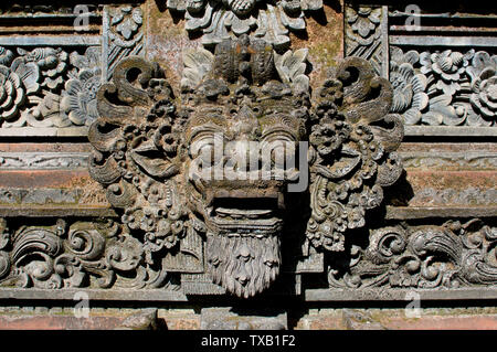 Close up picture of a typical Balinese Barong mask carved in stone as a decoration of a temple in Ubud, Bali - Indonesia Stock Photo