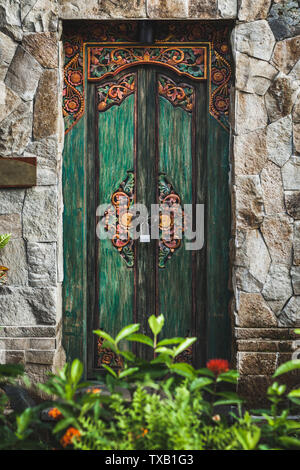 Traditional balinese handmade carved wooden door. Bali style furniture with ornament details Stock Photo