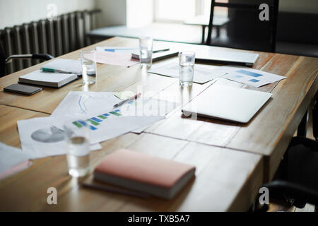 Background image of modern office interior with documents on wooden table in conference room, copy space Stock Photo