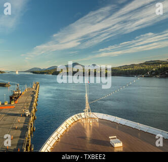 Sept 17, 2018 - Ketchikan, AK: Elevated view of emptying dock, Tongass Channel and cruise ship bow at end of day in sunset light. Stock Photo