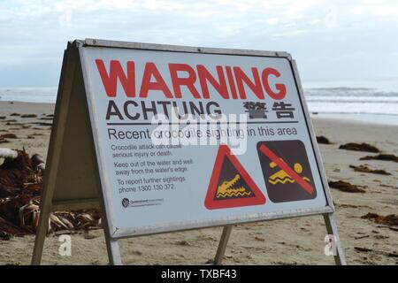 No Swimming warning sign for crocodiles on the beach in Port Douglas in Far North Queensland Stock Photo