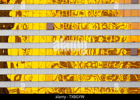 Abstract created by Golden yellow reflections on modern building windows
