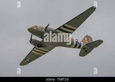 A Douglas C-47 Skytrain WW2 transport aircraft in the sky above Dunsfold Aerodrome, UK for the last ever Wings & Wheels airshow on the 16th June 2019. Stock Photo