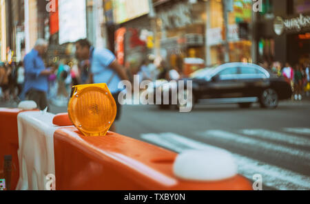 Construction zone shallow depth orange traffic barrier barrels to detour traffic around Stock Photo