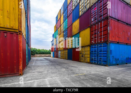 stack of containers with empty road in front Stock Photo