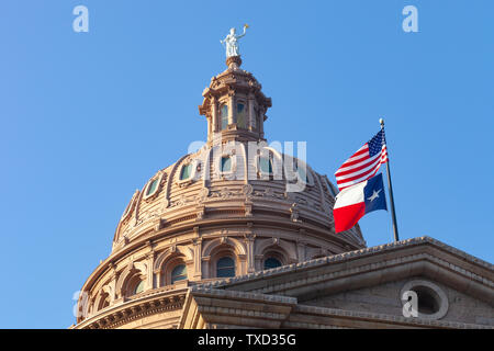 AUSTIN, TEXAS - JUNE 16, 2019 - Dome of Texas State Capitol building in Austin with USA and Texas flags flying on a sunny summer day Stock Photo