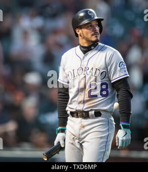 Colorado Rockies' Pat Valaika heads back to the dugout after being