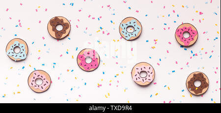 Creative yummy summer wallpaper with different donuts on white candy background, panorama Stock Photo