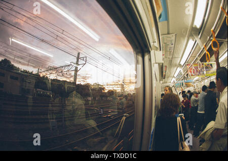 Reflections in the window of a commuter train in Tokyo, Japan. Stock Photo