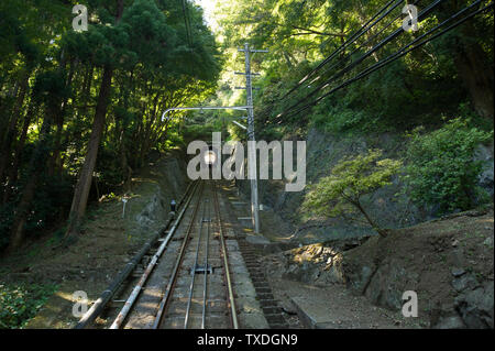 The funicular at Mount Takao park outside Tokyo regularly travels up and down the mountain, through the forest and a few tunnels. Stock Photo