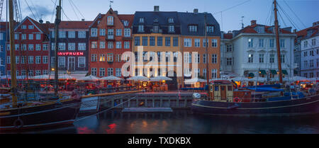 Nyhavn is a 17th-century waterfront, canal and entertainment district in Copenhagen, Denmark Stock Photo