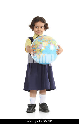 Portrait of a schoolgirl holding a globe Stock Photo