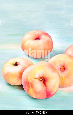 Saturn peaches on a teal background with a place for text Stock Photo