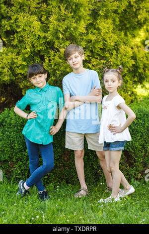 Group of happy children playing outdoors. Kids having fun in summer park. Stock Photo