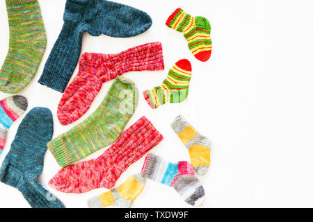 Top view of an assortment of colorful woolen socks of various sizes on white background Stock Photo