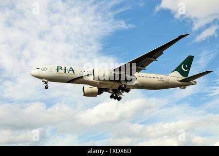 PIA ; Pakistan International Airlines aeroplane landing at Heathrow Airport ; London ; United Kingdom ; UK Stock Photo