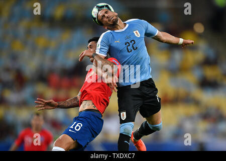 Rio De Janeiro, Brazil. 24th June, 2019. Uruguay's Martin Caceres (R) vies with Pablo Hernandez of Chile during the Copa America 2019 Group C match between Uruguay and Chile in Rio de Janeiro, Brazil, June 24, 2019. Uruguay won 1-0. Credit: Xin Yuewei/Xinhua/Alamy Live News Stock Photo