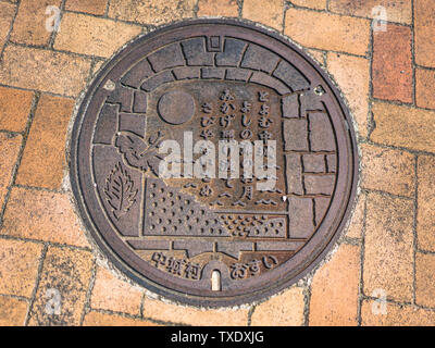Manhole on the Agaiteida bridge which means East Sun on the Hanta road near the North Nakagusuku Castle in Okinawa Island Stock Photo