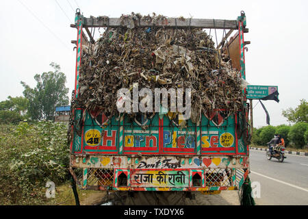 Back View of a Colourful Indian Rubbish Truck Loaded with Rubbish Stock Photo