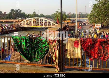 Clothing hanging out to dry over a Bridge Railing after a purifying Bath in the Ganges River Stock Photo